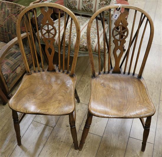 A pair of fruitwood and elm wheelback chairs
